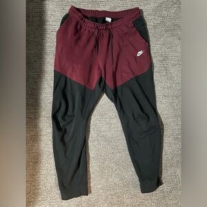Red and black Nike tech pants